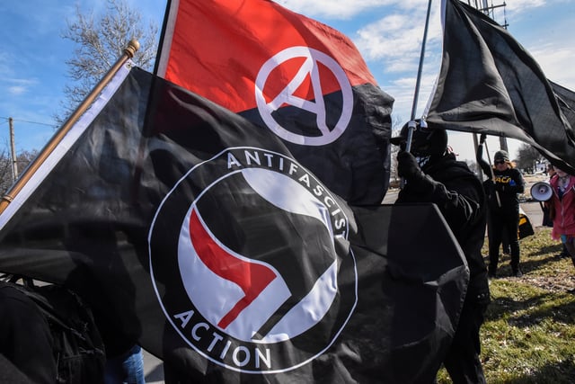 Members of the Great Lakes anti-fascist organization (Antifa) fly flags during a protest against the Alt-right outside a hotel in Warren, Michigan, U.S., March 4, 2018. REUTERS/Stephanie Keith/File Photo