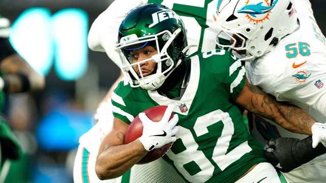 New York Jets wide receiver Xavier Gipson (82) tries to break the tackle of Miami Dolphins linebacker Quinton Bell (56), Sunday January 5, 2025, in East Rutherford.