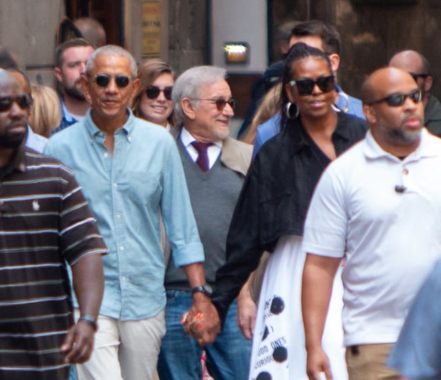 Former President Barack Obama (L), former First Lady Michelle Obama (R) and director Steven Spielberg (C) walk in a street of Barcelona on April 28, 2023. (Photo by XAVI HURTADO/AFP via Getty Images)