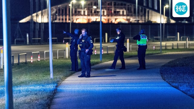 Police officers walk after all traffic has been closed at the Copenhagen Airport due to drone reports in Copenhagen, Denmark 
