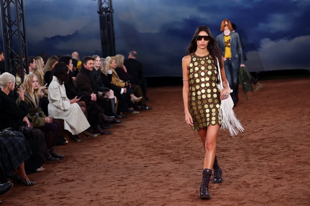 Models present creations at the Burberry catwalk show held during London Fashion Week in London, Britain, September 22, 2025. REUTERS/Isabel Infantes