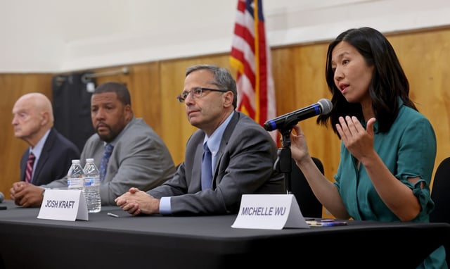 Mayor Michelle Wu speaks as Josh Kraft, Domingos DaRosa, and Robert Cappucci listen during a mayoral candidate forum at Prince Hall Grand Lodge in May. (Matt Stone/Boston Herald)