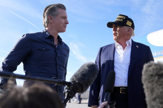 President Donald Trump talks with California Gov. Gavin Newsom after arriving on Air Force One at Los Angeles International Airport in Los Angeles, Friday, Jan. 24, 2025. Newsom signed legislation early in Trump’s second term, setting aside $25 million for the state’s Department of Justice to sue the administration. (AP Photo/Mark Schiefelbein)