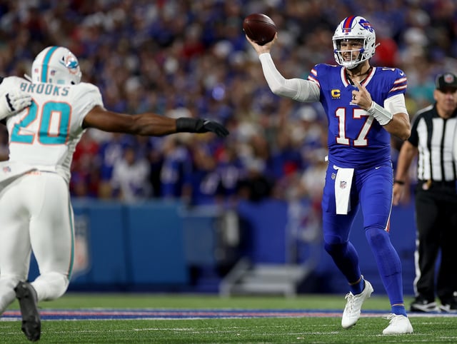 ORCHARD PARK, NEW YORK - SEPTEMBER 18: Josh Allen #17 of the Buffalo Bills makes a pass against Jordyn Brooks #20 of the Miami Dolphins in the first half of the game at Highmark Stadium on September 18, 2025 in Orchard Park, New York.