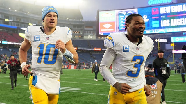 Dec 28, 2024; Foxborough, Massachusetts, USA; Los Angeles Chargers quarterback Justin Herbert (10) and safety Derwin James Jr. (3) run off the field after defeating the New England Patriots in the second half at Gillette Stadium. Mandatory Credit: David Butler II-Imagn Images
