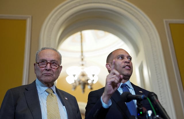 U.S. Senate Minority Leader Chuck Schumer listens as U.S. House Minority Leader Hakeem Jeffries (D-NY) speaks during a press conference at the U.S. Capitol in Washington, D.C., U.S., July 22, 2025. REUTERS/Nathan Howard/File Photo