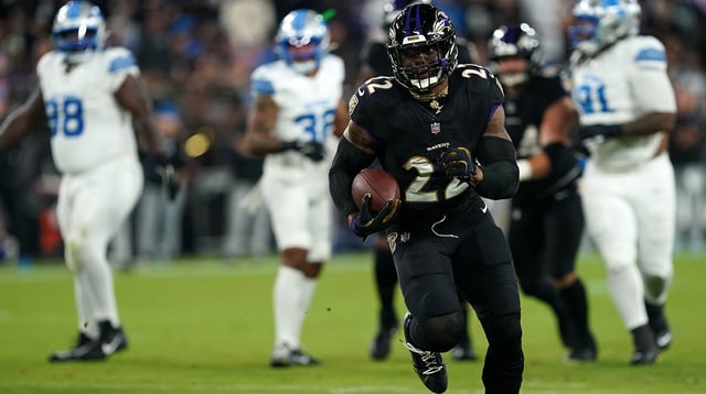 Sep 22, 2025; Baltimore, Maryland, USA; Baltimore Ravens running back Derrick Henry (22) rushes the ball against the Detroit Lions during the first half at M&T Bank Stadium. Mandatory Credit: Mitch Stringer-Imagn Images