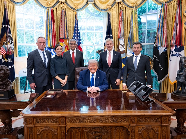 US President Donald Trump poses with HHS Secretary Robert F. Kennedy Jr., his daughter, Kick Kennedy, NIH Director Jay Bhattacharya, Administrator for the Centers for Medicare and Medicaid Services Dr. Mehmet Oz, FDA Commissioner Dr. Martin Makary, Monday, May 12, 2025, in the Oval Office following a media availability during a signing of an executive order demanding Pharma industry to cut prices at the White House (Official White House Photo by Joyce N. Boghosian)
