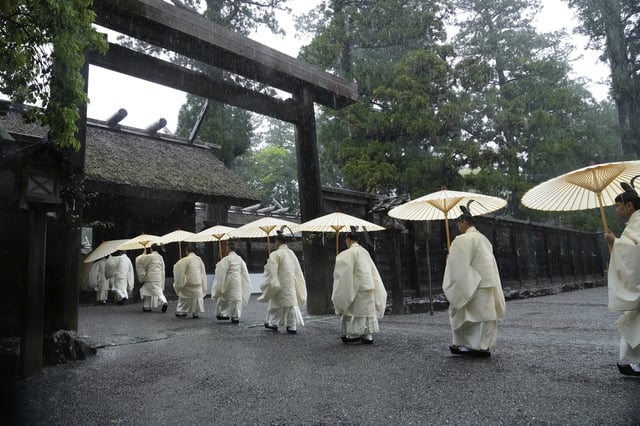Shinto priests march into the main palace of Toyoukedaijingu, also known as Geku, or the outer sanctuary, of the Ise Jingu shrine complex as they begin Yamaguchisai, a kickoff ceremony of Shikinen Sengu, concluding in 2033, in Ise, central Japan, May 2, 2025. (AP Photo/Hiro Komae)
