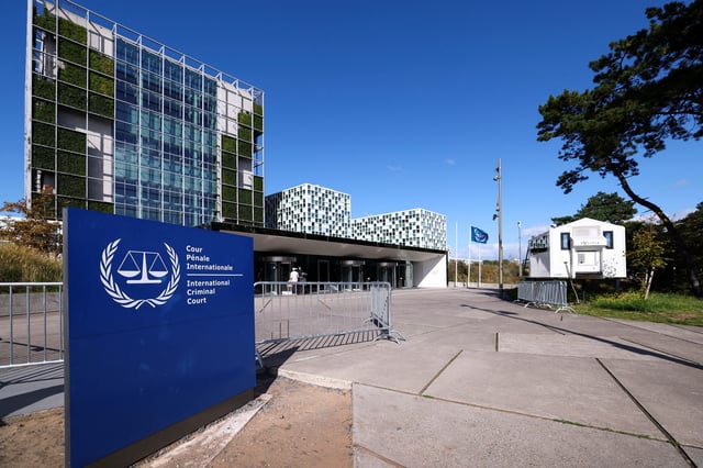 People stand outside the International Criminal Court (ICC), in The Hague, Netherlands, September 22, 2025. REUTERS/Piroschka van de Wouw/File Photo