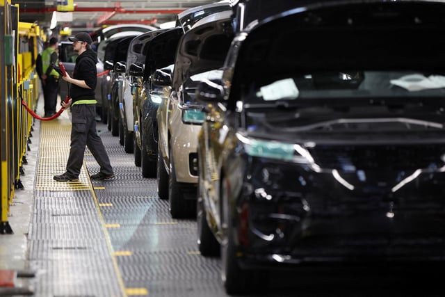 A member of staff works on the production line at Jaguar Land Rover’s factory in Solihull, Britain, December 15, 2022. REUTERS/Phil Noble/File Photo