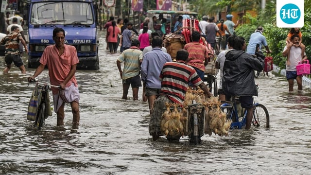 Kolkata: Commuters make their way through a waterlogged road following rain, in Kolkata, Tuesday, Sept. 23, 2025. (PTI Photo/Manvender Vashist Lav)(PTI09_23_2025_000096B)