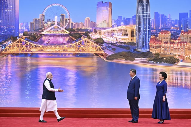 Indian Prime Minister Narendra Modi, left, approaches Chinese President Xi Jinping and wife Peng Liyuan at a ceremony welcoming heads of states in Tianjin, China.