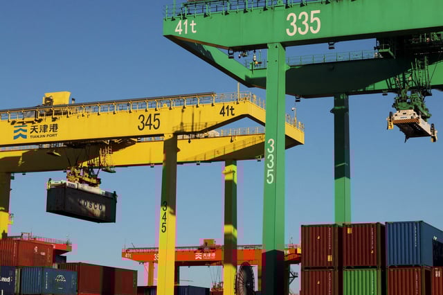 A gantry crane lifts a container at a port in Tianjin, China February 8, 2025. REUTERS/Florence Lo/File Photo