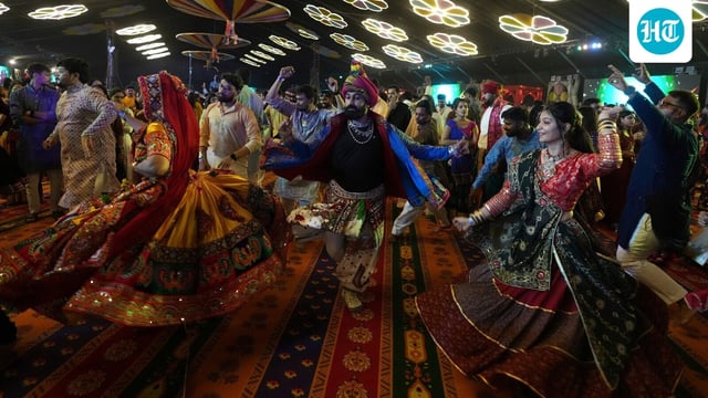 People wearing traditional attire perform Garba, a traditional dance, on the first night of Navratri in Gujarat