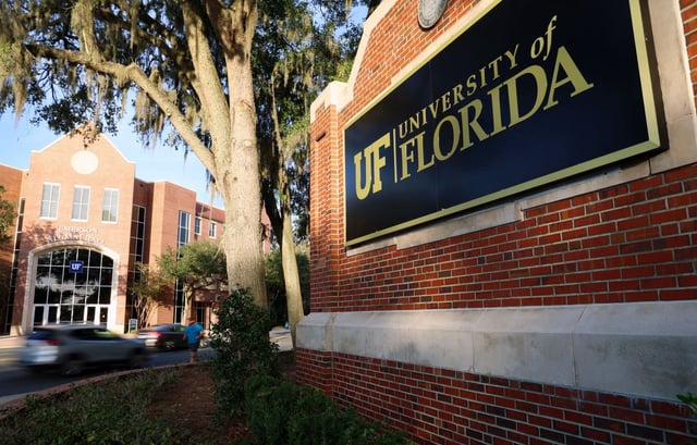 Cars speed past University of Florida entrance sign located at the intersection of University Avenue and Gale Lemerand Drive in Gainesville, Fla. (Azhalia Pottinger/Fresh Take Florida)