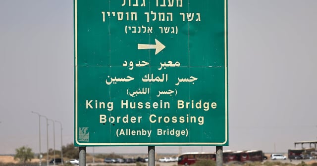 A sign points Palestinians towards the Allenby Bridge, a gateway between the West Bank and Jordan.  EPA
