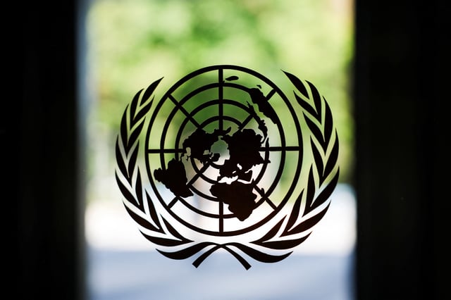 The United Nations logo adorns a window at U.N. headquarters in New York City, U.S., September 18, 2025. REUTERS/Jeenah Moon/ File Photo