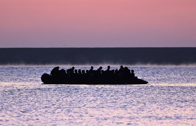 A group of migrants on an inflatable dinghy leave the coast of northern France in an attempt to cross the English Channel to reach Britain as tougher migration controls were announced, from the beach of Petit-Fort-Philippe in Gravelines, near Calais, France, July 17, 2025. REUTERS/Gonzalo Fuentes/File Photo