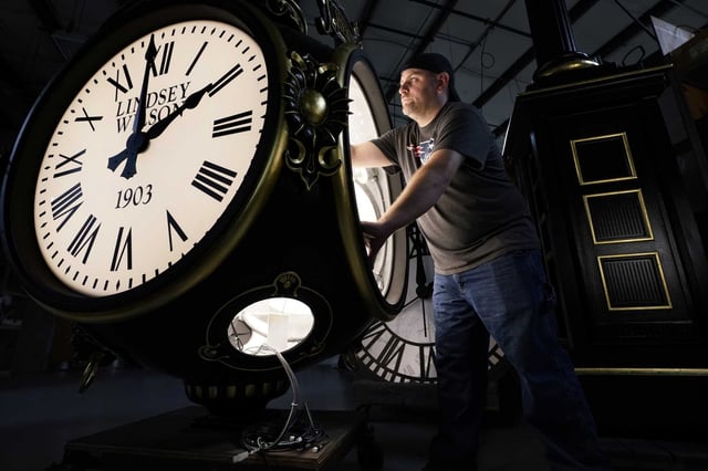 Dan LaMoore works on a Seth Thomas Post Clock at Electric Time Company on Oct. 23, 2020, in Medfield, Mass. Daylight saving time ends at 2 a.m. local time Sunday, Nov. 3, 2024, when clocks are set back one hour.