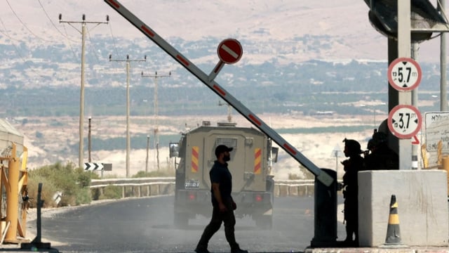 A man walks at a barrier, at the Allenby Crossing between the West Bank and Jordan on Sept. 8. 
