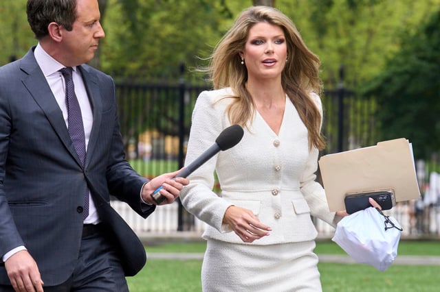 Lindsey Halligan speaks with a reporter outside of the White House, Wednesday, Aug. 20, 2025.