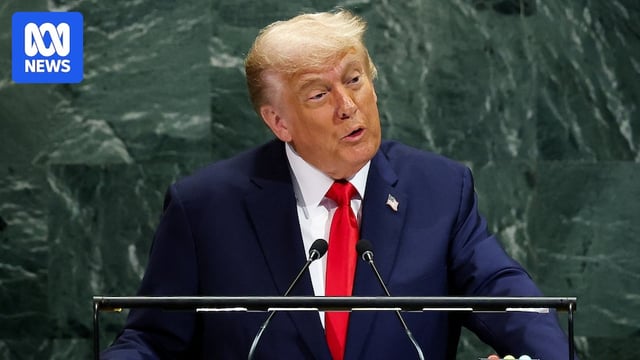 Donald Trump speaks in front of green marble.