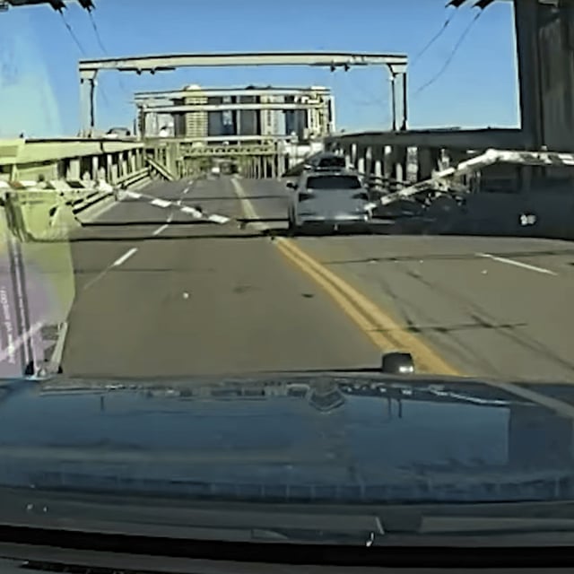 Seattle police{ }said a fleeing car jumped the gap on the partially lowered University District Bridge, went airborne, then landed on the other side of the bridge and continued north. (PHOTO: Seattle Police Department)