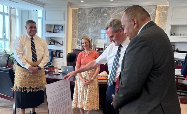 Elder Peter F. Meurs, General Authority Seventy, second from left, presents Honourable Hu’akavemeiliku Siaosi Sovaleni, prime minister of the Kingdom of Tonga, with a copy of the Family Proclamation on Thursday, July 4, 2024, at the capital in Nuku’alofa. Sister Maxine Meurs, and Elder Sione Tuione, an Area Seventy, watch.