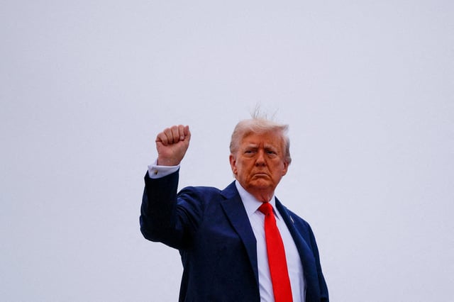 U.S. President Donald Trump gestures, as he boards Air Force One to depart for a memorial service for slain conservative commentator Charlie Kirk, at Joint Base Andrews, Maryland, U.S., September 21, 2025.  REUTERS/Brian Snyder/File Photo