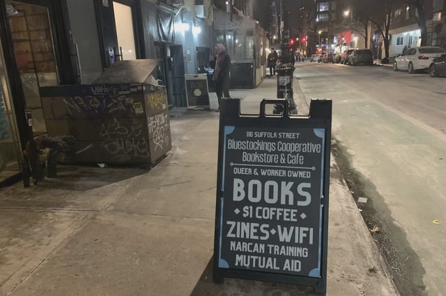 A chalkboard in front of Bluestockings Cooperative in 2024.
