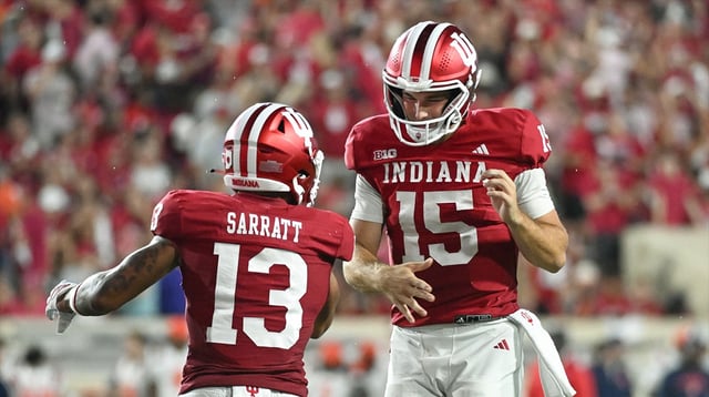 Sep 20, 2025; Bloomington, Indiana, USA; Indiana Hoosiers wide receiver Elijah Sarratt (13) and IIndiana Hoosiers quarterback Fernando Mendoza (15) celebrate after a touchdown during the second half against the Illinois Fighting Illini at Memorial Stadium. Mandatory Credit: Robert Goddin-Imagn Images