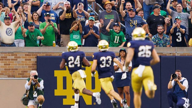 Fans celebrate after Notre Dame running back Jadarian Price (24) returned a kick-off for a touchdown during the first half of a NCAA football game against Purdue at Notre Dame Stadium on Saturday, Sept. 20, 2025, in South Bend.