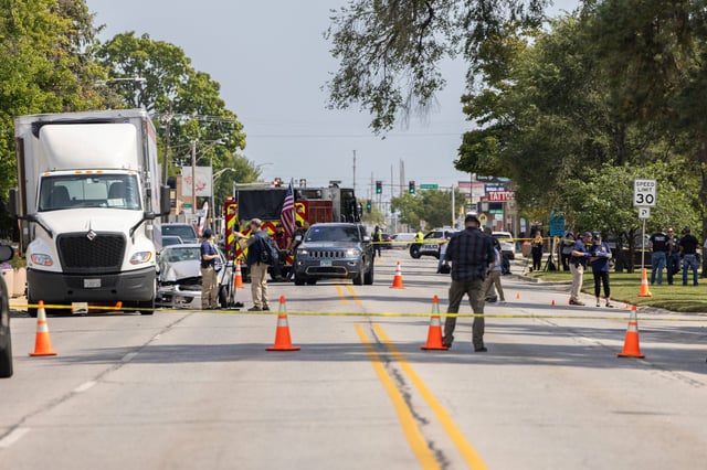 Law enforcement personnel investigate after the Department of Homeland Security said an Immigration and Customs Enforcement agent fatally shot a man in the Franklin Park suburb of Chicago on Friday, Sept. 12, 2025. (Candace Dane Chambers/Chicago Sun-Times via AP)