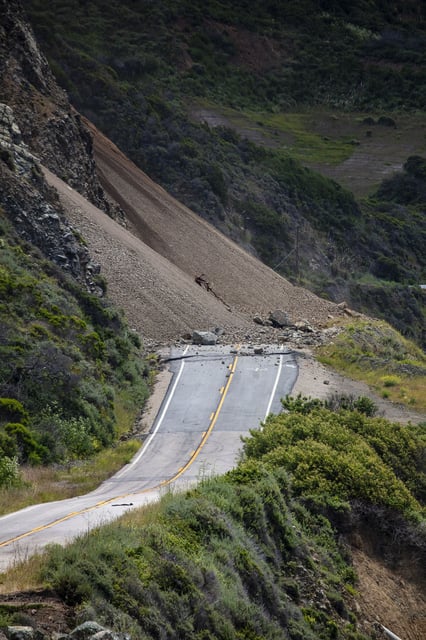 Rocks and debris cover Highway 1 at Regent's Slide in Big Sur in 2024..