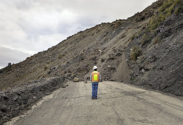 Bret Haney, construction inspector with Caltrans, looks at the south side of a landslide on Wednesday, May 24, 2017, after a massive slide went into the Pacific Ocean in Big Sur, Calif.