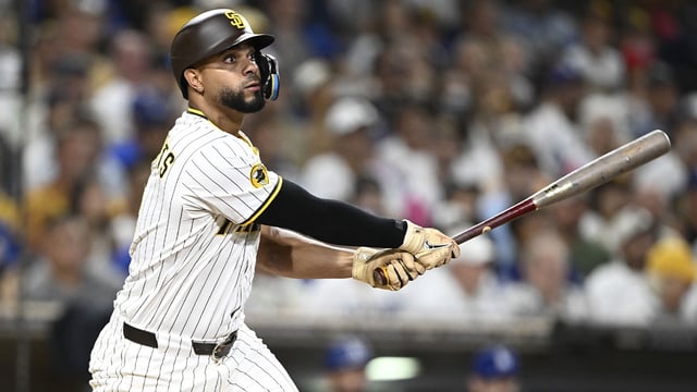 Aug 23, 2025; San Diego, California, USA; San Diego Padres shortstop Xander Bogaerts (2) hits an RBI double during the eighth inning against the Los Angeles Dodgers at Petco Park. Mandatory Credit: Denis Poroy-Imagn Images