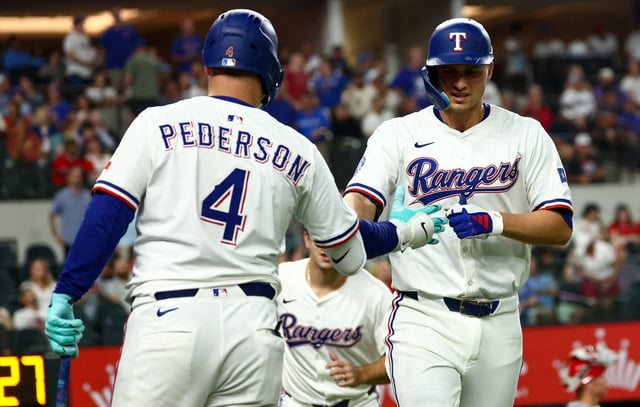 Aug 27, 2025; Arlington, Texas, USA;  Texas Rangers shortstop Corey Seager (5) celebrates with Texas Rangers designated hitter Joc Pederson (4) after hitting a two-run home run during the fourth inning against the Los Angeles Angels at Globe Life Field. Mandatory Credit: Kevin Jairaj-Imagn Images/File Photo