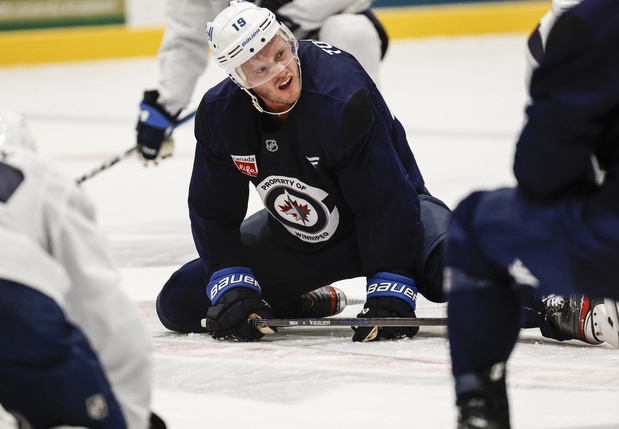 Winnipeg Jets' Jonathan Toews (19) jokes around as he leads stretching after their NHL training camp session in Winnipeg, Thursday, Sept. 18, 2025. Toews was second in ice time among the forwards with 18:36 over 22 shifts. The Jets lost 3-2 to the Edmonto Oilers on Tuesday night. 