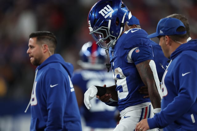 EAST RUTHERFORD, NEW JERSEY - SEPTEMBER 21: Tyrone Tracy Jr. #29 of the New York Giants helped off the field during the first quarter against the Kansas City Chiefs at MetLife Stadium on September 21, 2025 in East Rutherford, New Jersey. (Photo by Elsa/Getty Images)