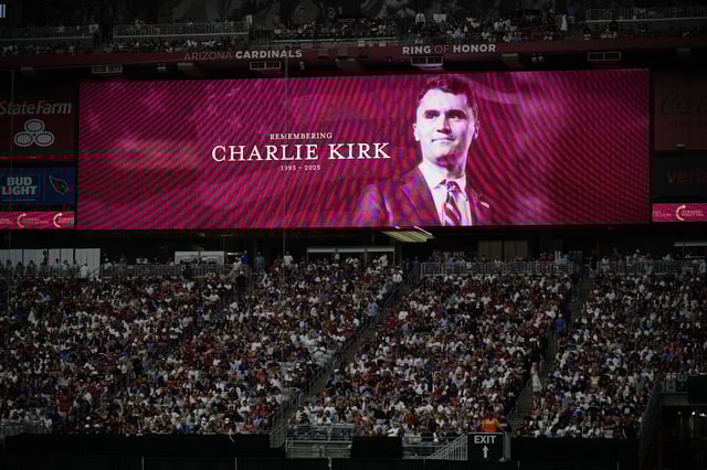 A photo of the conservative activist Charlie Kirk is seen on a large screen during a memorial for Kirk, Sunday, Sept. 21, 2025, at State Farm Stadium in Glendale, Ariz. (AP Photo/John Locher)