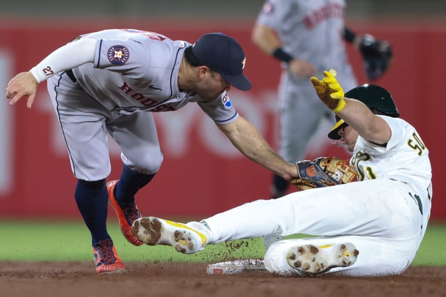 Houston Astros second baseman Jose Altuve, left, tags out Athletics' Tyler Soderstrom, right, as he is picked off during the third inning of a baseball game Tuesday, Sept. 23, 2025, in West Sacramento, Calif. (AP Photo/Scott Marshall)