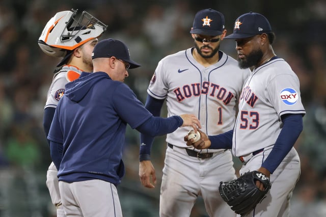 Houston Astros starting pitcher Cristian Javier (53) hands the ball to manager Joe Espada, front left, after being pulled during the fifth inning of a baseball game against the Athletics, Tuesday, Sept. 23, 2025, in West Sacramento, Calif. (AP Photo/Scott Marshall)