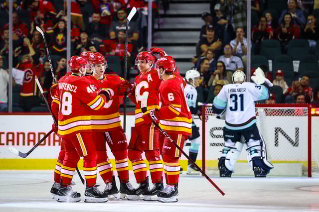 Calgary Flames center Yegor Sharangovich celebrates his goal with teammates against Seattle Kraken goaltender Philipp Grubauer (Sergei Belski-Imagn Images)