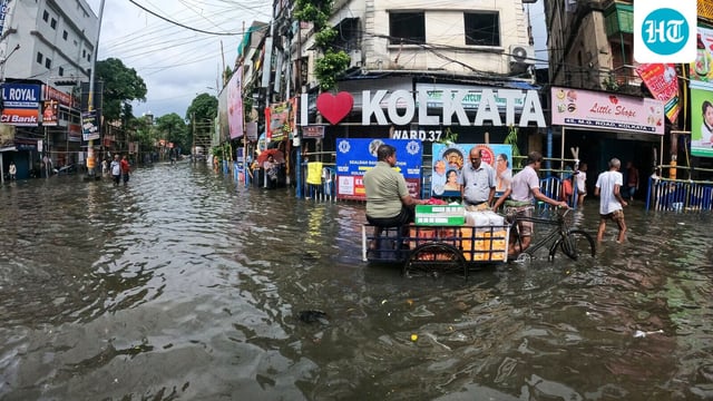 A view of a waterlogged street after heavy rainfall in Kolkata on Tuesday, leading to knee-deep water.