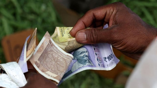 A man counts Indian currency notes at a market in Bengaluru, India, August 1, 2025. File Image/Reuters