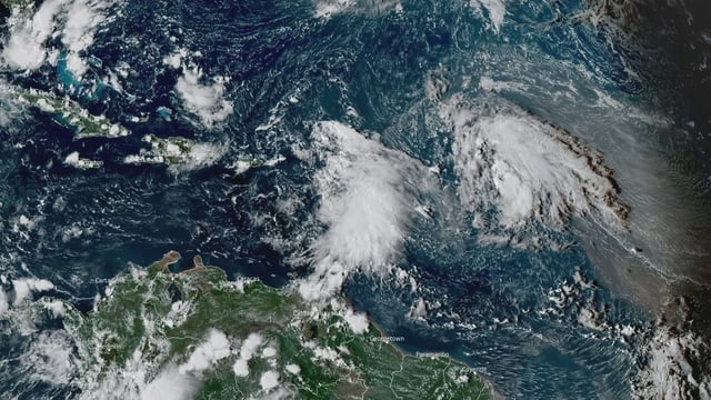 Satellite image showing two tropical waves in the Atlantic basin at 19:40 UTC on September 23, 2025. Credit: NOAA/GOES-East, RAMMB/CIRA, The Watchers