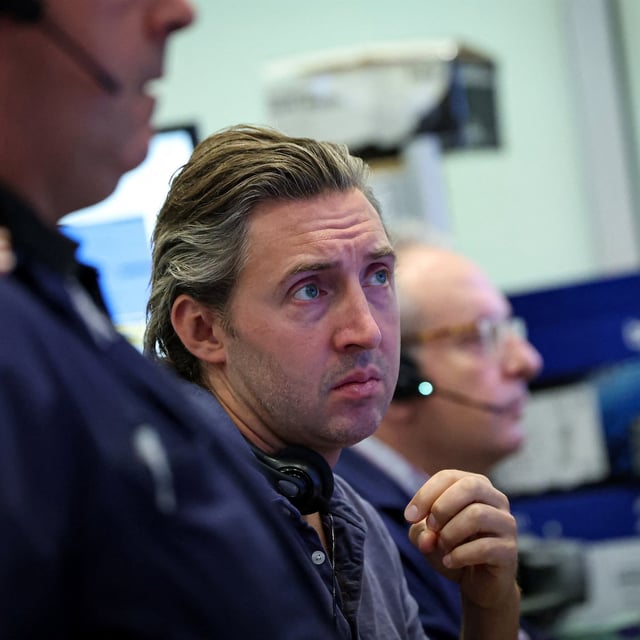 FILE PHOTO: Futures-options traders work on the floor at the American Stock Exchange (AMEX) at the New York Stock Exchange (NYSE) in New York City, U.S., September 15, 2025.  REUTERS/Brendan McDermid/File Photo
