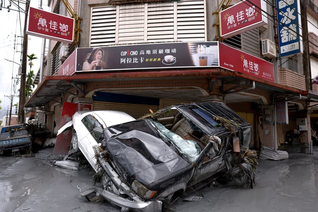 Damaged cars lie piled up in mud, following flooding brought by Super Typhoon Ragasa in Hualien, Taiwan, September 24, 2025. REUTERS/Ann Wang