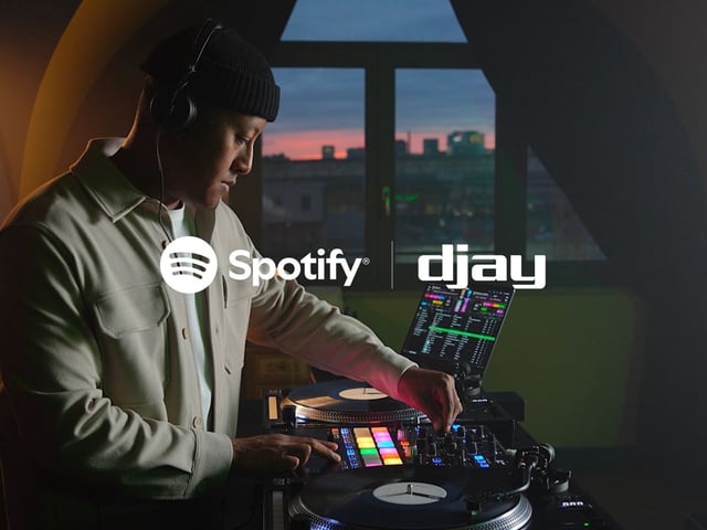 A promotional image celebrating the launch of Spotify integration in the djay app.